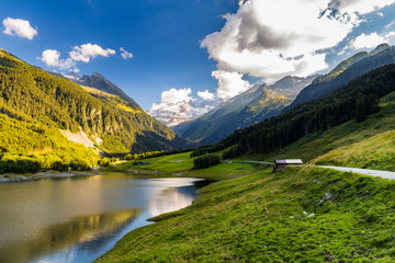 Naklejka na ściany i meble Colorful summer morning on the Speicher Durlassboden lake. View of Richterspitze mountain range in the Austrian Alps. Austria, Europe.