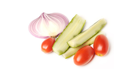 salted cucumber, red cherry tomatoes and sliced red onion on white, traditional snack while drinking vodka