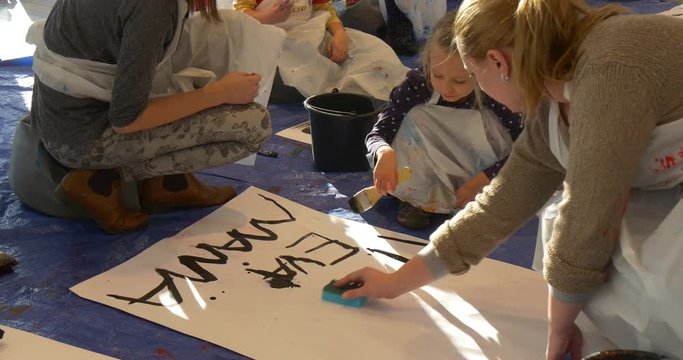 Woman Wipes the Paper Sheet Kid is Writing Words on a Paper Painting Black Kids Are Painting in Art Gallery Kindergarten Classroom Educators Animators