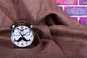 Alarm clock with a black hipster mustache