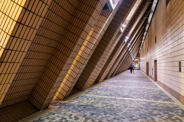 Fototapeta premium Illuminated public outdoor pass of Cultural Centre building in Kowloon, Hong Kong
