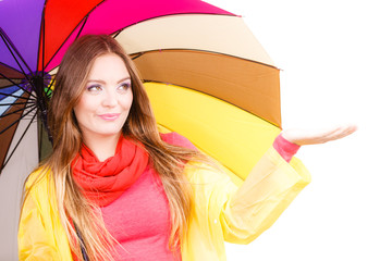 Woman in rainproof coat under umbrella