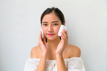 young beautiful woman cleaning face