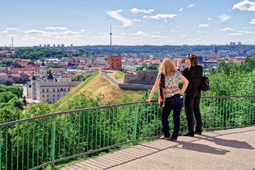 Women taking photo of Gediminas Tower and Lower Castle Vilnius