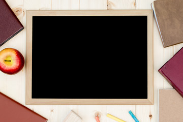 Books, chalkboard and place for text. View from above. Flat lay