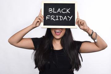Woman holding chalkboard with text black friday.