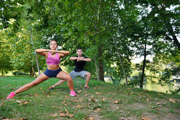 Couple stretching before jogging at the park