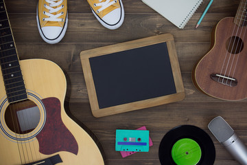 Wooden table of music composer, guitar, ukulele, notebook, audio cassettes, microphone, tape...