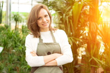 Young attractive woman working at the plants nursery