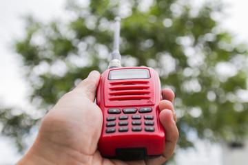 Red radio communication on working women hand
