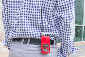 Red radio communication on working women hand