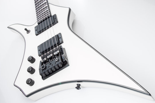 White electric guitar with black trim on white background