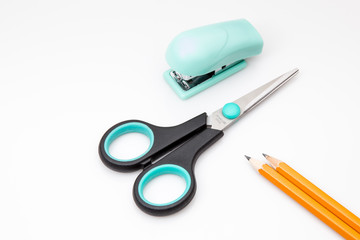 Pencils stapler and scissors on white background