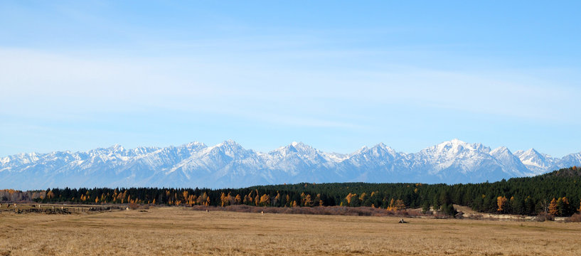 blue sky over the vast steppes, Tunka valley, mountains covered with snow, Sayan mountains. Used deep toning of the photo 