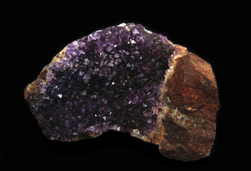 gemstone, druse of purple amethyst on black background, used toning og the photo 
