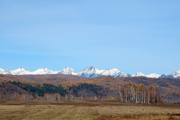 Fototapeta premium blue sky over the vast steppes, Tunka valley, mountains covered with snow, Sayan mountains. Used deep toning of the photo 