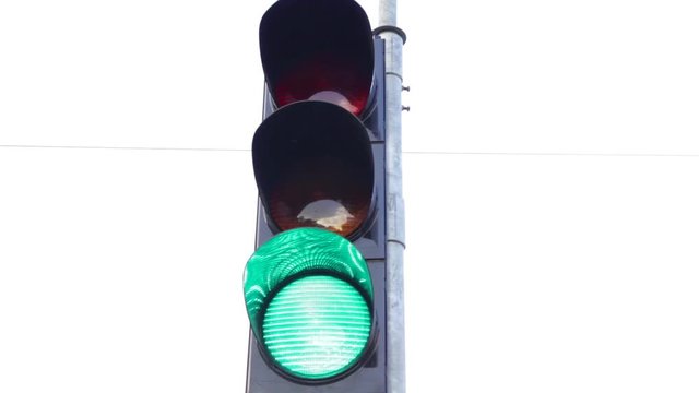 traffic lights on street turning blinking from red stop to green go semaphore
