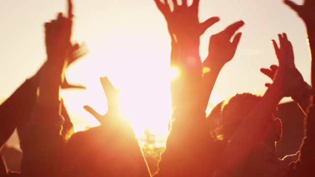 Group of People Dancing and Raising Hands Outdoors in Sunlight. Slow Motion Shot. Shot on RED Cinema Camera in 4K (UHD).