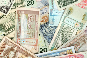 Fototapeta na wymiar background consisting of randomly mixed banknotes from different countries
