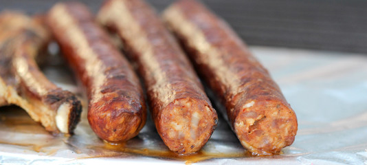 Grilling sausages on barbecue grill. Selective focus