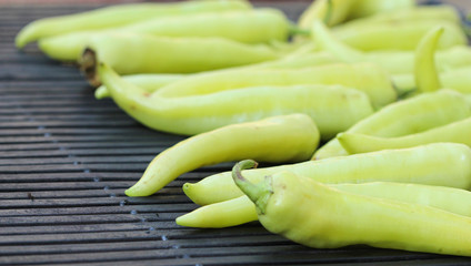Green sweet pepper is fried on a grill