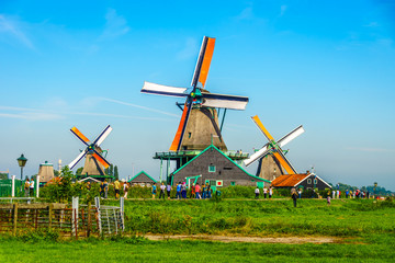 Fototapeta premium Fully operational historic Dutch Windmills along the Zaan River at the village of Zaanse Schans in the Netherlands
