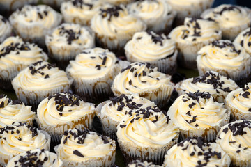 Many muffins with white creme and chocolate 