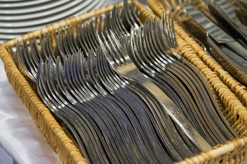 Lot of forks lies in the basket ready for lunch