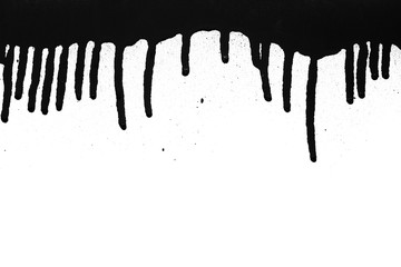 Black color spray paint on a white background paper