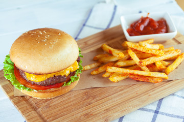 burger and french fries on wooden table