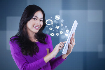 Asian girl with social media icon on tablet