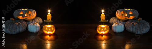 Halloween pumpkin and candle light on the black table