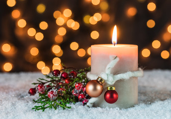 Christmas decoration background lights snow and burning candle