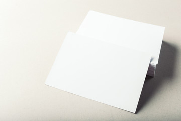 blank business cards on grey background
