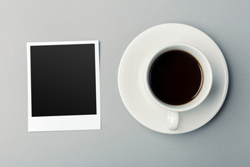 smartphone beside of coffee on wooden table.