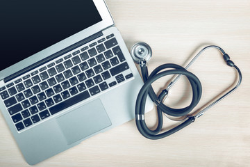 Stethoscope on laptop, close-up