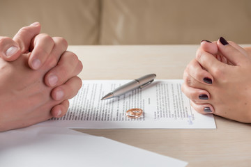 Obraz na płótnie Canvas wife and husband signing divorce documents or premarital agreement