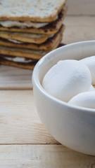 Fototapeta na wymiar Marshmallows in bowl and smores