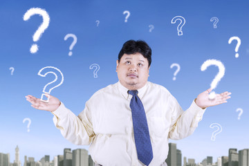 Overweight businessman and question mark