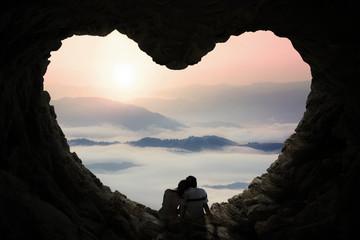 Romantic couple enjoy mountain view in cave