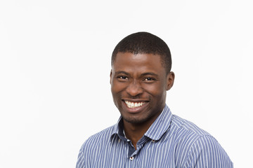 Portrait of Afro-American businessman happy smiling in studio. Handsome man in shirt looking at camera isolated on white.