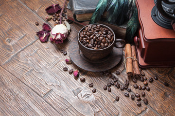 Cup of coffee, dry rose and grinder