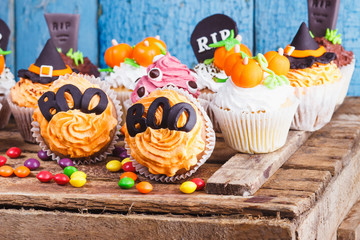 Halloween cupcakes with colored decorations