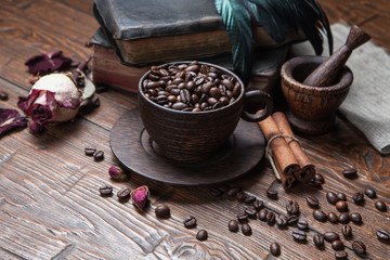 Cup of coffee, dry rose and grinder