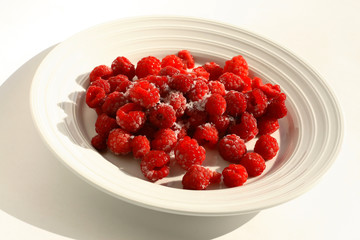 frozen raspberries on a white plate