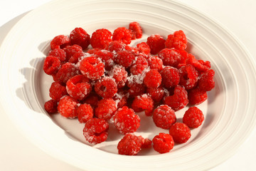 frozen raspberries on a white plate