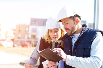 Two workers checking last details on a construction site