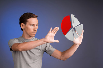 Man in t-shirt working with pie chart on blue background.