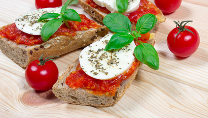 Italian bruschetta with cherry tomatoes, mozzarella & fresh basil.