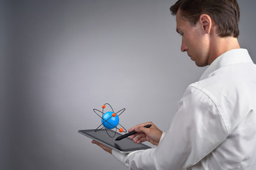 Man scientist holding a tablet PC with atom model, research concept